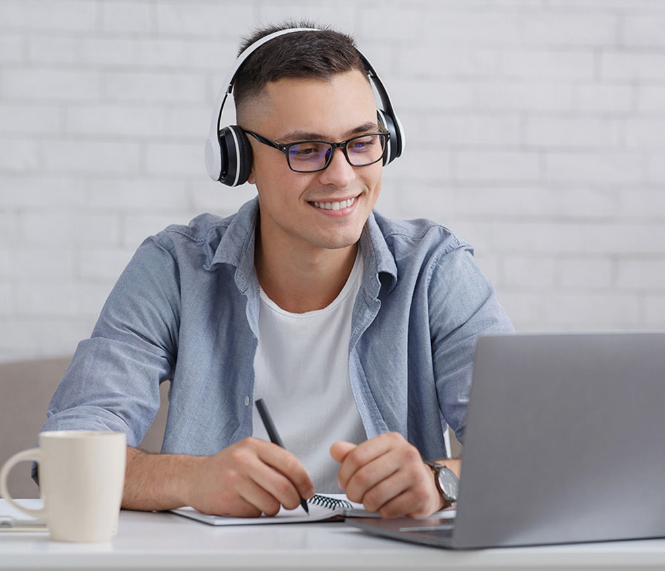 A man wearing a headset with laptop