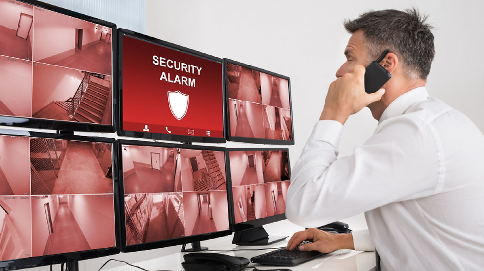 Security officer monitoring distribution center surveillance.