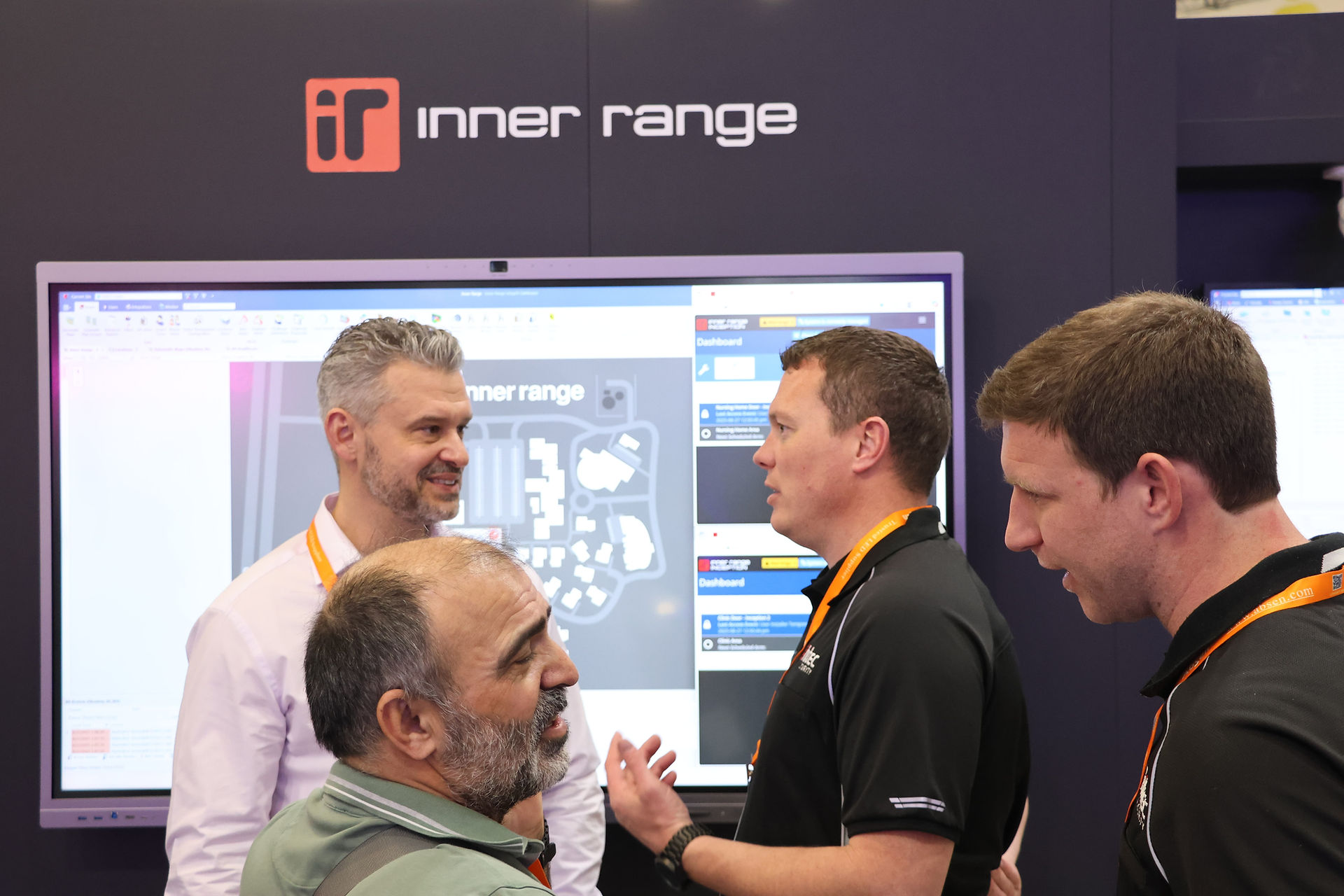Inner Range staff infront of a display board